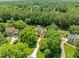Aerial view of home nestled amongst mature trees in a well established neighborhood at 5108 Briton Pl, Fuquay Varina, NC 27526