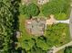 Aerial view of home featuring a large backyard, mature landscaping and circular driveway at 5108 Briton Pl, Fuquay Varina, NC 27526