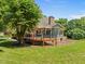 Beautiful backyard with a large deck, screened in porch and mature landscaping at 5108 Briton Pl, Fuquay Varina, NC 27526
