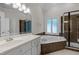 Bathroom featuring tub, shower with glass door, and vanity with granite countertop at 5108 Briton Pl, Fuquay Varina, NC 27526