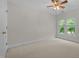 Bright, carpeted bedroom featuring a ceiling fan and window at 5108 Briton Pl, Fuquay Varina, NC 27526