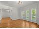 Spacious empty room with hardwood floors and multiple windows at 5108 Briton Pl, Fuquay Varina, NC 27526