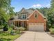 Charming two-story brick home with an attached two-car garage at 5108 Briton Pl, Fuquay Varina, NC 27526