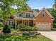 Beautiful brick home with manicured lawn, covered porch, and two-car garage at 5108 Briton Pl, Fuquay Varina, NC 27526
