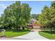 Spacious brick home with mature trees and a long driveway at 5108 Briton Pl, Fuquay Varina, NC 27526