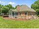 Brick home featuring a screened in porch, and well manicured landscaping at 5108 Briton Pl, Fuquay Varina, NC 27526