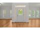 Bright foyer with hardwood floors and decorative glass front door at 5108 Briton Pl, Fuquay Varina, NC 27526