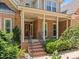 Inviting front porch with brick steps and decorative railing leading to red door at 5108 Briton Pl, Fuquay Varina, NC 27526