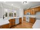Well-lit kitchen with oak cabinets, stainless appliances, white counters, and backyard access at 5108 Briton Pl, Fuquay Varina, NC 27526