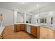 Kitchen island with sink, oak cabinets, white countertops, and stainless dishwasher at 5108 Briton Pl, Fuquay Varina, NC 27526