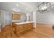 Expansive open floor plan kitchen features an island and cabinetry with modern accents at 5108 Briton Pl, Fuquay Varina, NC 27526