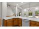 Spacious kitchen with oak cabinets, white countertops, stainless dishwasher, and natural lighting at 5108 Briton Pl, Fuquay Varina, NC 27526