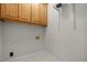 Functional laundry room with overhead cabinets and hook-ups at 5108 Briton Pl, Fuquay Varina, NC 27526