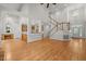 Open-concept living area showcasing staircase, kitchen access, and natural light at 5108 Briton Pl, Fuquay Varina, NC 27526