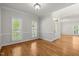 Bright living area features hardwood floors, large windows, and natural light at 5108 Briton Pl, Fuquay Varina, NC 27526