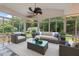Stylish sunroom with checkered floors, large windows, and comfortable furniture at 5108 Briton Pl, Fuquay Varina, NC 27526