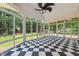 Bright sunroom featuring checkered flooring and large windows with views of the backyard at 5108 Briton Pl, Fuquay Varina, NC 27526