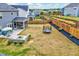 Aerial view of a backyard with a trampoline, fire pit, patio, landscaped areas, and fencing at 512 Teal Lake Dr, Holly Springs, NC 27540