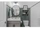 Charming bathroom featuring a grey vanity, decorative mirror, and a combined shower and toilet at 512 Teal Lake Dr, Holly Springs, NC 27540