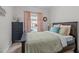 Cozy bedroom featuring neutral walls, carpet flooring, and a view of the pool through a bright window at 512 Teal Lake Dr, Holly Springs, NC 27540