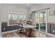 Cozy dining area with a rustic wooden table, lots of natural light, and sliding glass doors to the patio at 512 Teal Lake Dr, Holly Springs, NC 27540