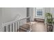 Bright hallway with a staircase, natural light from a window, and a neutral color scheme at 512 Teal Lake Dr, Holly Springs, NC 27540