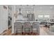 Modern kitchen featuring stainless steel appliances, pendant lighting, and a breakfast bar with seating at 512 Teal Lake Dr, Holly Springs, NC 27540