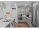 Well-equipped kitchen with stainless appliances, sleek cabinetry, and a center island, perfect for cooking and entertaining at 512 Teal Lake Dr, Holly Springs, NC 27540