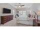 Bright main bedroom with plush carpet, a large window, tray ceilings, and stylish furnishings for a serene atmosphere at 512 Teal Lake Dr, Holly Springs, NC 27540