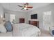 Well-lit main bedroom with a ceiling fan, neutral tones, carpet, and a comfortable bed, designed for relaxation at 512 Teal Lake Dr, Holly Springs, NC 27540