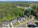 Aerial view of a neighborhood showcasing beautiful homes with lush greenery and surrounding trees at 517 Myrna Ln, Wake Forest, NC 27587