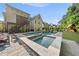 Expansive backyard with pool, hot tub, waterslide, playset, lush greenery, and outdoor seating, perfect for entertaining and relaxation at 517 Myrna Ln, Wake Forest, NC 27587