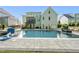 Backyard showcasing a spacious pool with basketball hoop, surrounded by a well-manicured lawn and the home's architecture at 517 Myrna Ln, Wake Forest, NC 27587