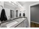 Modern bathroom featuring double sinks, a gray countertop, and modern lighting fixtures at 517 Myrna Ln, Wake Forest, NC 27587