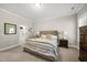 Comfortable bedroom featuring a stylish upholstered headboard, neutral color scheme, and carpeted flooring at 517 Myrna Ln, Wake Forest, NC 27587