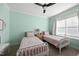 Bright bedroom with two twin beds, a ceiling fan, and neutral carpet at 517 Myrna Ln, Wake Forest, NC 27587