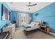 Cozy bedroom with an accent wall, ceiling fan, a nearby dresser, and carpeted floors at 517 Myrna Ln, Wake Forest, NC 27587