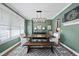 Charming dining room with modern light fixture, and a rustic wooden table set on an area rug at 517 Myrna Ln, Wake Forest, NC 27587
