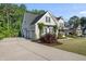 Beautiful side and front view of home showcasing landscaping, driveway and three-car garage at 517 Myrna Ln, Wake Forest, NC 27587