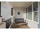 Cozy front porch with brick flooring, a charming porch swing, and a decorative star accent at 517 Myrna Ln, Wake Forest, NC 27587