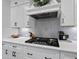 Close-up of kitchen featuring sleek white cabinetry, modern appliances, and stylish backsplash at 517 Myrna Ln, Wake Forest, NC 27587