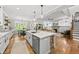 Open concept kitchen with stainless steel appliances, large island, and seamless flow to living areas at 517 Myrna Ln, Wake Forest, NC 27587