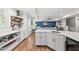 Basement kitchenette with white cabinets, sink, wine cooler and access to a fully equipped living space at 517 Myrna Ln, Wake Forest, NC 27587