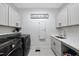 Bright laundry room with modern appliances and custom cabinetry providing ample storage and convenience at 517 Myrna Ln, Wake Forest, NC 27587