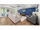 Inviting living room featuring a dark blue accent wall, recessed lighting, and modern furniture at 517 Myrna Ln, Wake Forest, NC 27587
