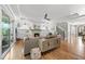 Bright living room featuring fireplace, built-in shelves, hardwood floors, and seamless indoor-outdoor flow at 517 Myrna Ln, Wake Forest, NC 27587