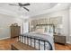 Elegant main bedroom with tray ceiling, hardwood floors, and soft natural light, creating a peaceful retreat at 517 Myrna Ln, Wake Forest, NC 27587