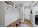Well-organized mudroom with a built-in bench, coat hooks, and overhead storage, offering style and functionality at 517 Myrna Ln, Wake Forest, NC 27587