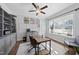 Well-lit home office with a ceiling fan, built-in shelving, and a comfortable workspace at 517 Myrna Ln, Wake Forest, NC 27587