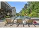 Inviting pool area featuring lounge chairs, perfect for relaxation, with a backdrop of lush landscaping and the home's architecture at 517 Myrna Ln, Wake Forest, NC 27587